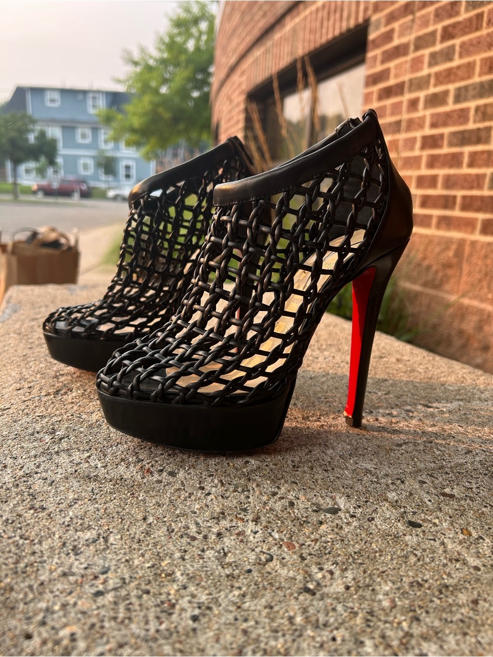 “RED BOTTOMS”. Christian Louboutin. Black woven cage peep toe heels